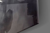 Graphite-and-gold feather glass wall art in boutique-hotel lounge
