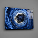 Cobalt sea-swirl glass wall art over walnut console in coastal living room