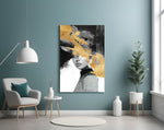 Gold-and-charcoal woman cinematic glass wall art in boutique-hotel lounge