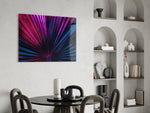 Stage-lit palm-fan cinematic glass wall art over master-bedroom headboard