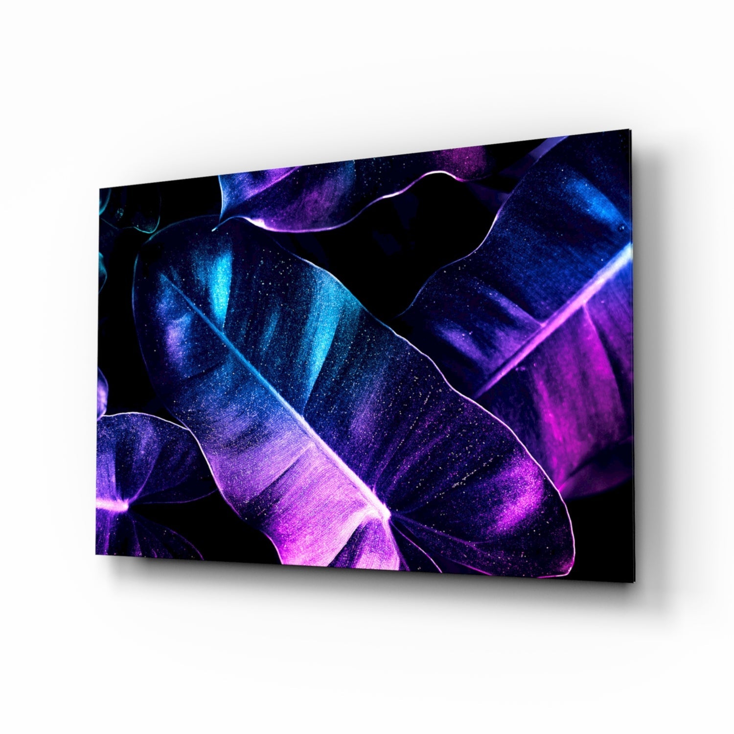 Glowing neon leaves cinematic glass wall art above black media console