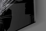 Half-lit panther cinematic glass wall art in steakhouse private dining room