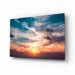 Sunset cloudscape cinematic glass wall art over walnut console in designer hotel-resort lobby